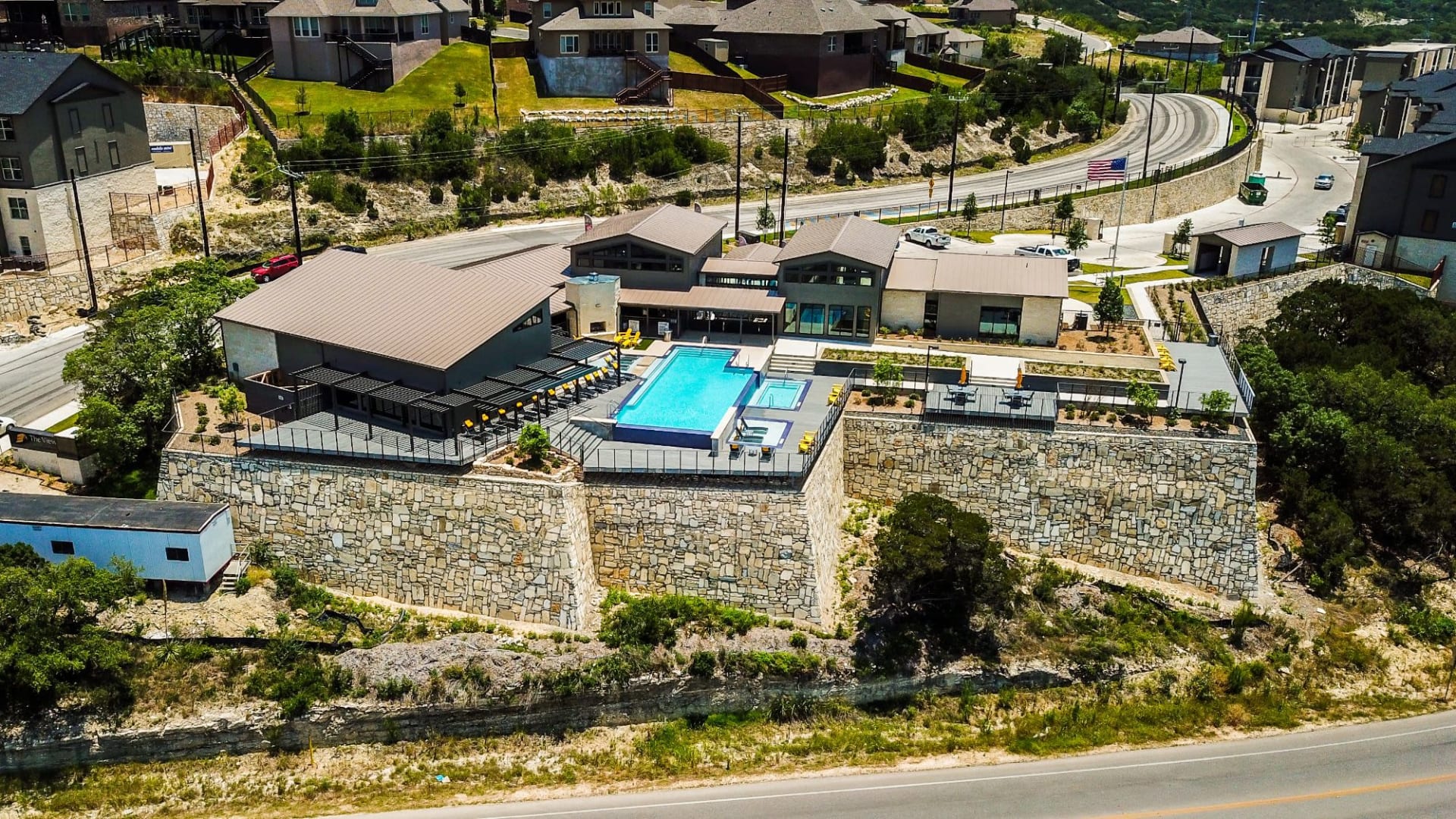 an aerial view of a house with a pool and a hillside at The  View at Crown Ridge