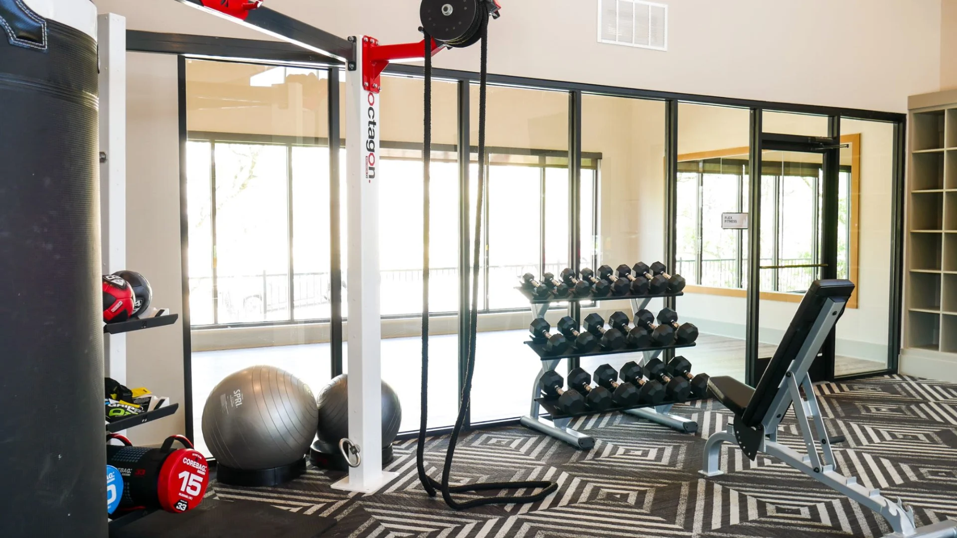 a gym room with a weight machine, exercise equipment and a mirror at The  View at Crown Ridge