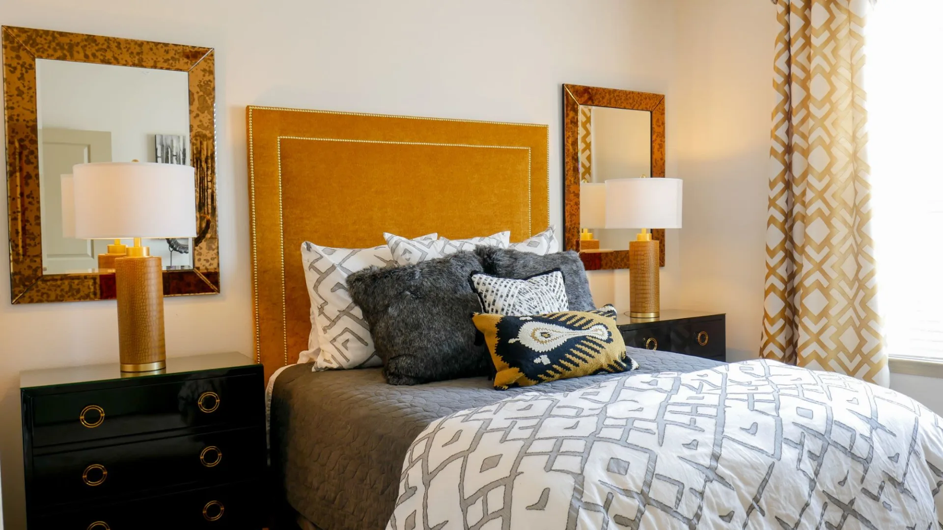 a bedroom with a bed, nightstands and a mirror at The  View at Crown Ridge