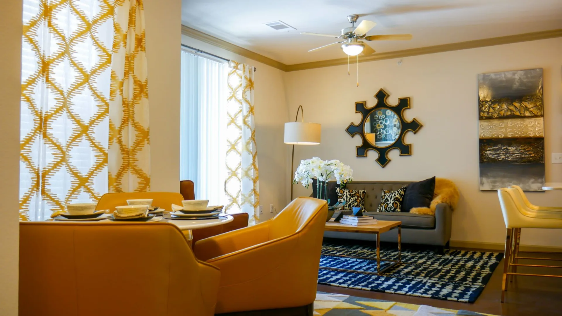 a living room with yellow furniture and a large window at The  View at Crown Ridge