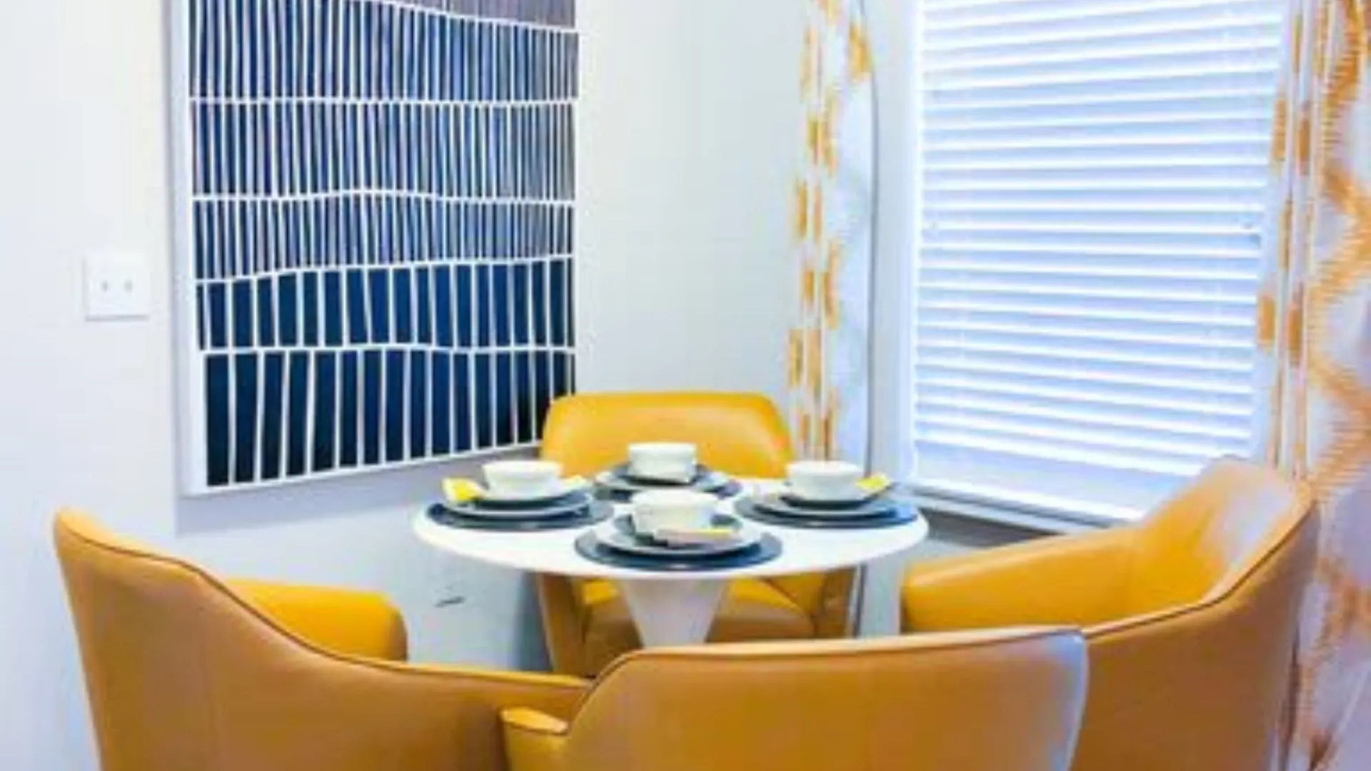a dining room with yellow chairs and a table at The  View at Crown Ridge