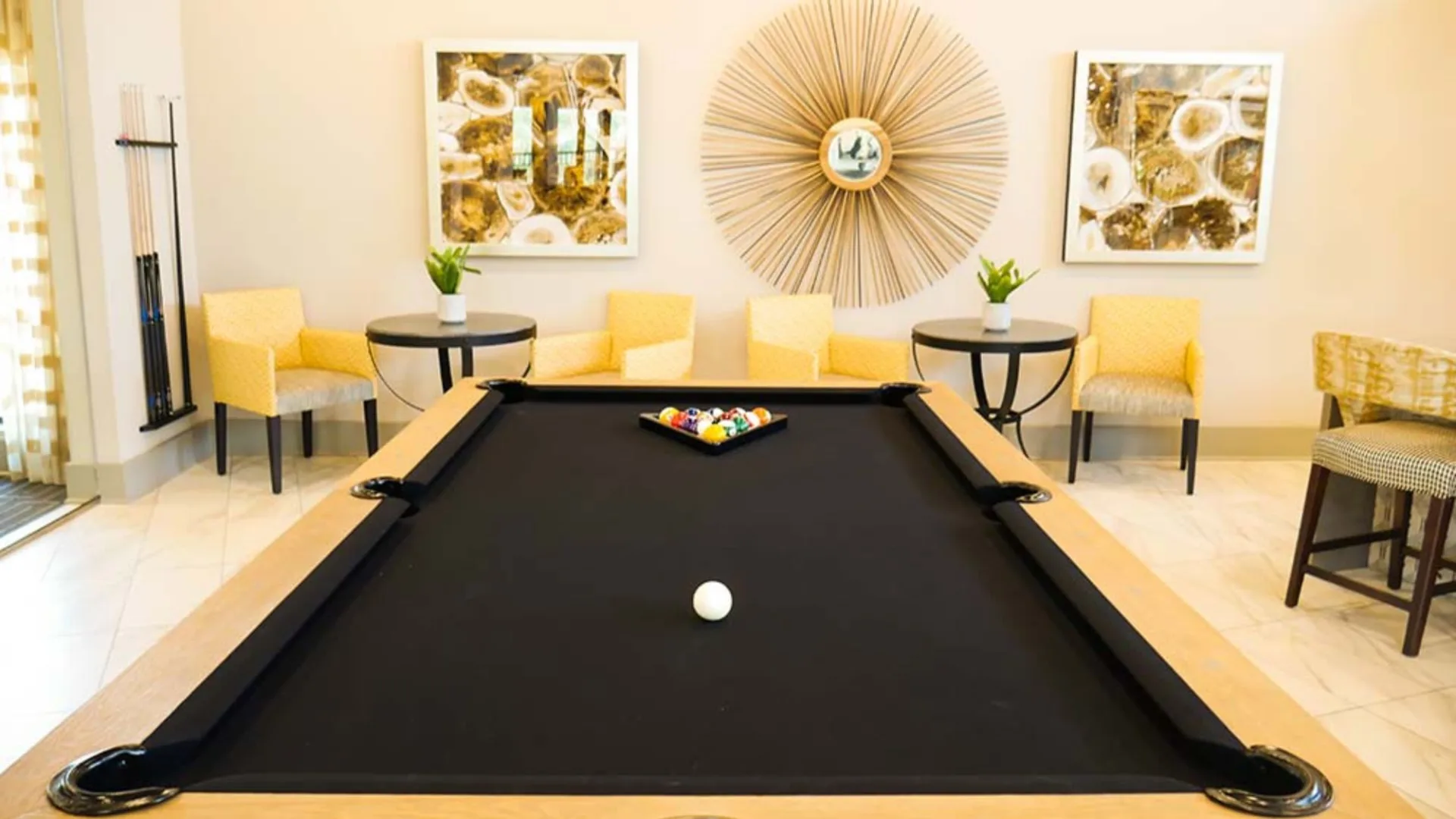 pool table in a living room with yellow chairs at The  View at Crown Ridge
